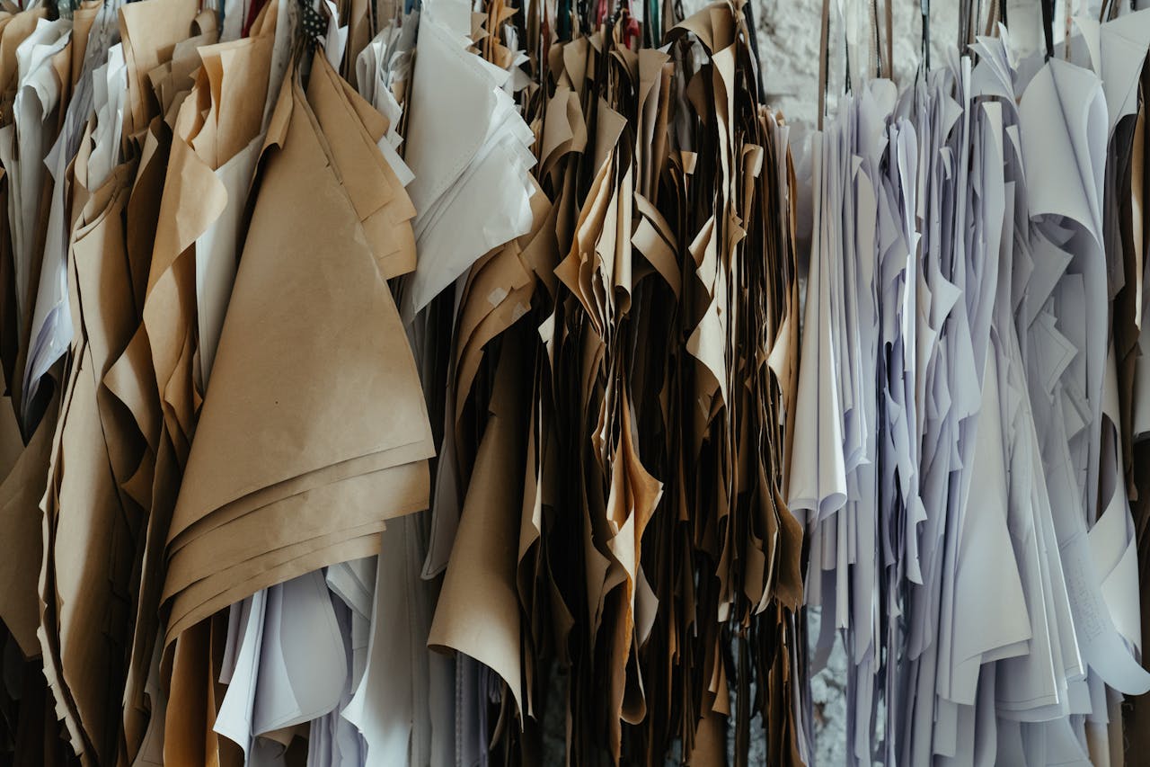 An array of fabric patterns hanging in a tailoring workshop, showcasing diverse designs.