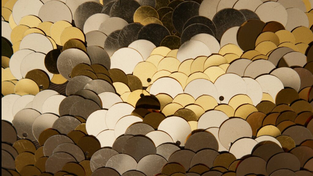 Elegant and shimmering sequin pattern in gold and silver hues, perfect for festive and luxury designs.